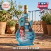 Blue glass guitar-shaped bottle featuring David Bowie Aladdin Sane portrait and Bombay Sapphire branding on a patio.!