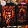 David Bowie Halloween Costume 2026 T-Shirt featuring a graphic of Bowie with a lightning bolt, pumpkins, and a graveyard.