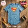 DC Comics Superman Blue Compression T-Shirt with iconic red and yellow chest logo on a rustic wooden background.