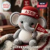Crocheted gray elephant plush toy wearing a red cap with Greek letters Delta Sigma Theta and holding a red pennant flag.!