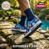 Custom blue sneakers featuring Dragon Ball Z Super Saiyan Goku graphics on stone path near water.!