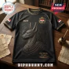 Black athletic t-shirt featuring a golden Anubis emblem, Egypt national crest, and 2026 text on a wooden desk background.!