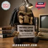 Crocheted brown and grey Predator plush holding a white sign reading Emotional Support The Predator on a wooden desk.!