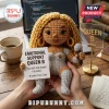 Crochet doll of Queen B with blonde curly yarn hair, silver metallic outfit, and microphone, holding an affirmation card.!