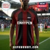 Black and dark red soccer jersey featuring white ENHYPEN text and One, Two, Connect slogan on a stadium background.!