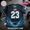 Black baseball jersey featuring Enhypen Jay, number 23, nebula print, and signature on a wooden surface with concert tickets.!
