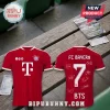 FC Bayern Munich red soccer jersey with number 7, sponsor logo, and white autographs on a wooden bench.!