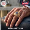 FIFA World Cup 2026 Gold Championship Ring featuring a round blue stone center and encrusted pave diamonds on a hand.