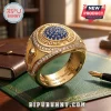 FIFA World Cup 2026 Gold Championship Ring featuring blue gemstone center, diamond accents, and etched trophy side detail.