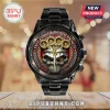Five Finger Death Punch wristwatch with black metal band, silver skull graphic, and red dial face on wood surface.!