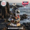 Facet-cut crystal bust of Gene Simmons from KISS with black and white makeup, red tongue, set on a rock by the ocean.!