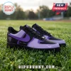 Custom Nike Air Force 1 sneakers in black and purple leather sitting on green grass with personalized text label.!