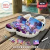 White foam clogs featuring GTA 6 graphics with palm trees and pink sunset colors on a wooden dock background.!