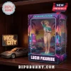 Lucia figurine in window box packaging with synthwave palm tree backdrop, blonde hair, glasses, and teal crop top.!