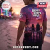 Man wearing a Grand Theft Auto Six graphic t-shirt with a sunset beach city background and neon logo on back.!