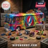 Grateful Dead tie-dye tour bus building block set with band member minifigures and instruments on a wooden floor.!