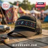 Black trucker hat with woven multicolored Aztec pattern band and circular lightning bolt logo patch on wooden table.!