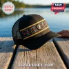 Black trucker hat with mesh back, featuring a colorful geometric woven band and a lightning bolt logo emblem on a dock.!