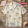 Off-white short-sleeve button-down shirt with a tropical palm tree and beach hut pattern on a wooden background.!