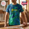 Man wearing a blue and green marble-print t-shirt with a yellow hammer logo and Fallout text in a woodworking workshop.!