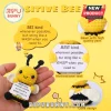Yellow and black crochet bee plush holding a white sign that reads BEE kind whenever possible, but sting like a WASP.!