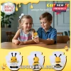 Children holding a yellow and black crocheted bee plush toy with a tag reading BEE kind whenever possible.!