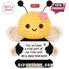 Amigurumi bee plush toy with yellow head, black body, pink flower, and a sign reading You've been a vital part of our hive.!
