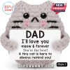 Grey crochet cat plush holding a white sign that reads DAD I'll love you meow and forever with black and pink details.!