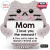 Grey crochet cat amigurumi plush holding a sign that says Mom I love you the meowst on a white background.!