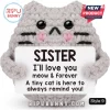 Grey crocheted plush cat holding a sign reading SISTER I'll love you meow & forever with black plastic eyes and pink blush.!