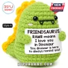 Green crochet dinosaur plush with yellow spikes holding a sign that reads Friendsaurus Rawr means I love you in Dinosaur.!