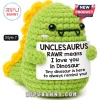 Green crochet dinosaur plush toy with yellow dorsal spikes holding a sign reading Unclesaurus Rawr means I love you.!