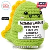 Green crochet Mommysaurus dinosaur plush holding a sign reading RAWR means I love you in Dinosaur.!
