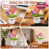 Crochet potted flowers with pink, purple, and white blooms holding a card reading Never Forget The Difference That You Make.!
