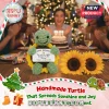 Crocheted green turtle plush in a sunflower shell holding a sign that says Happy Birthday The world is brighter.!