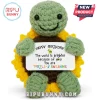 Crocheted green turtle plush in a sunflower shell holding a white card reading Happy Birthday and Turtle-y Awesome.!
