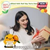 Yellow crocheted bumblebee plush holding an orange flower and a card with positive text in front of a smiling woman.!