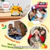 Yellow crocheted bumblebee plush holding a sunflower and a sign reading Positive Bee on a wooden desk near a rotary phone.!
