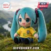 Plush Hatsune Miku figure wearing a yellow Brazil soccer jersey with number 11, seated on grassy hillside.!