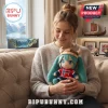 Young woman holding a teal-haired anime plush wearing a Viking helmet and a red Norway jersey with number 9 on a sofa.!