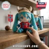 Hatsune Miku plush doll wearing a Viking helmet and a Norway soccer jersey with the number 9, on a wooden shelf.!