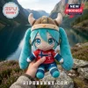 Hatsune Miku plush doll wearing a viking helmet and Norway national soccer jersey with number 9 on a blurred mountain lake.!
