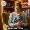 Hatsune Miku plush doll wearing a Viking helmet and Norway soccer jersey held by a woman in a velvet chair.!
