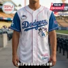 White LA Dodgers baseball jersey with blue sleeves featuring Hello Kitty graphics, pink piping, and repeating logo patterns.!