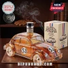 Herbie the Love Bug car-shaped glass decanter filled with amber liquid, next to a matching themed cardboard gift box.!