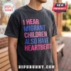 Human Rights Migrant Children Heartbeats T-Shirt with pink and blue text on a washed charcoal grey cotton background.