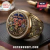 Gold Iron Maiden 50th anniversary championship ring with Eddie character motifs, blue inlay, and crystal accents on black mat.!