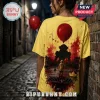 Yellow cotton t-shirt featuring Pennywise from IT, a red balloon, and Georgie by a storm drain in a watercolor art style.!