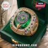 Jannik Sinner Wimbledon champion ring featuring a large green gemstone, gold detailing, and purple tennis emblem in a box.!