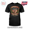 January 6th Never Forget It Was Treason Patriot black T-shirt featuring a red, white, and blue shield emblem graphic.
